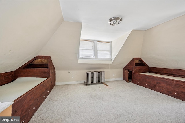 bonus room featuring baseboards, carpet flooring, radiator heating unit, and vaulted ceiling