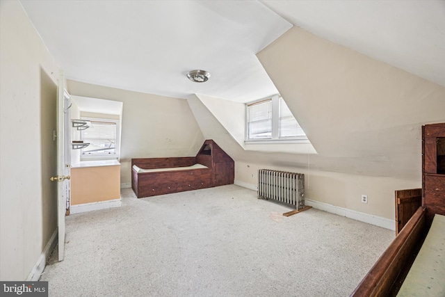 bonus room with radiator, baseboards, vaulted ceiling, and carpet flooring