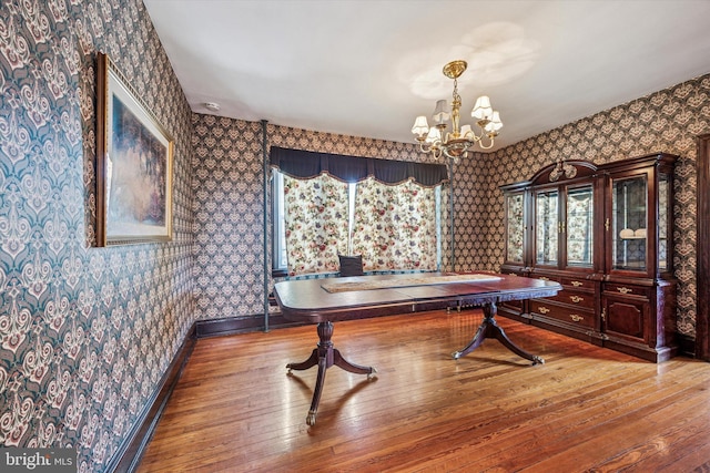 game room featuring baseboards, a chandelier, hardwood / wood-style flooring, and wallpapered walls