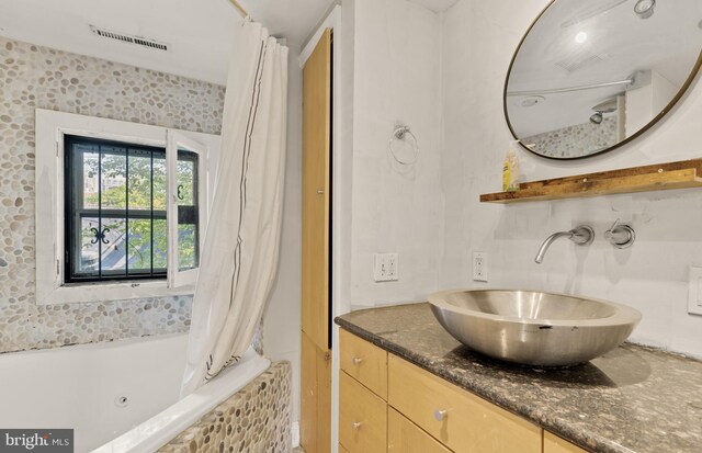 full bath with visible vents, shower / bathtub combination with curtain, and vanity