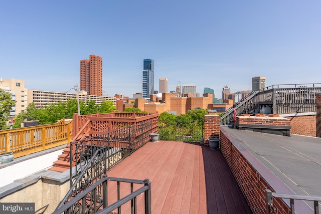 wooden deck with a city view
