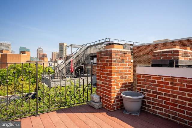 wooden deck featuring a city view