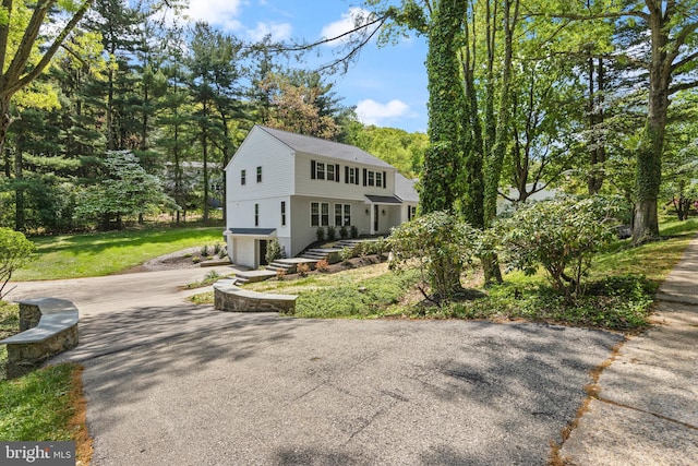 view of front of home featuring a garage and aphalt driveway