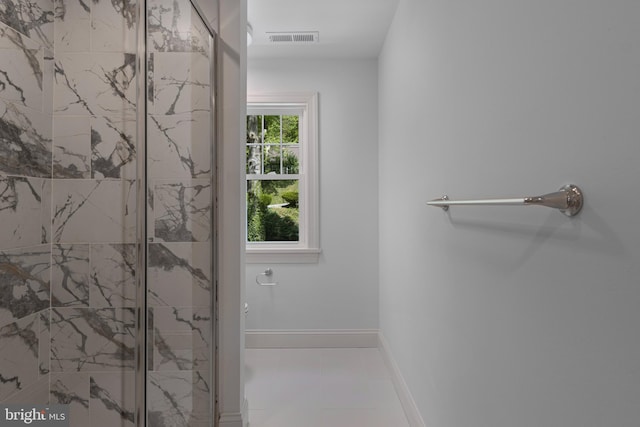 full bath with toilet, a marble finish shower, visible vents, tile patterned floors, and baseboards
