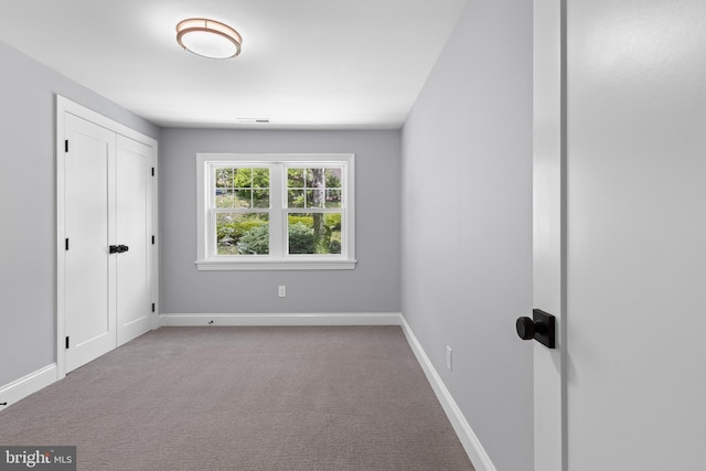 unfurnished bedroom with baseboards, visible vents, and carpet floors