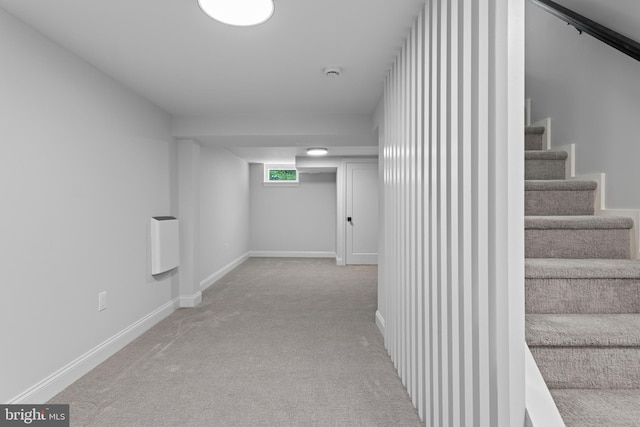 hallway with stairway, baseboards, and carpet floors