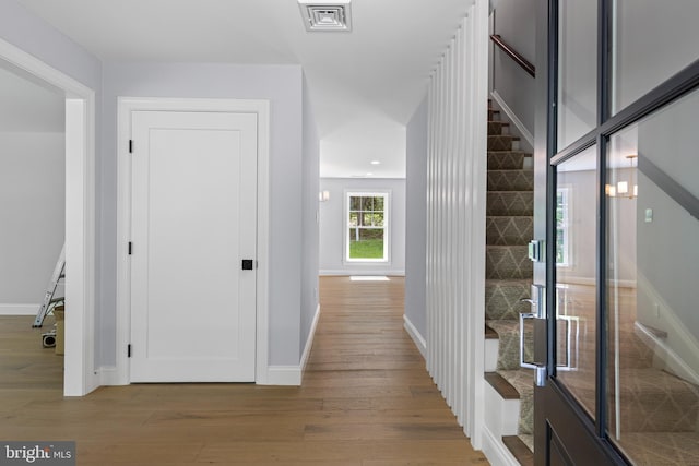 hall with baseboards, recessed lighting, visible vents, and wood finished floors