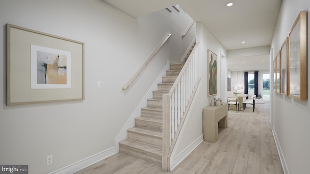 stairway with recessed lighting, baseboards, and wood finished floors