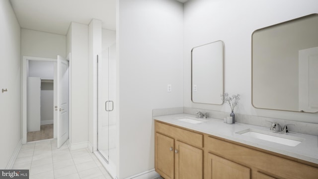 full bathroom with a sink, tile patterned floors, a shower stall, and double vanity