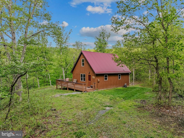 82 Vista River Ln, Paw Paw, WV 25434 - view of property exterior featuring a view of trees, metal roof, a wooden deck, a lawn, and a standing seam roof