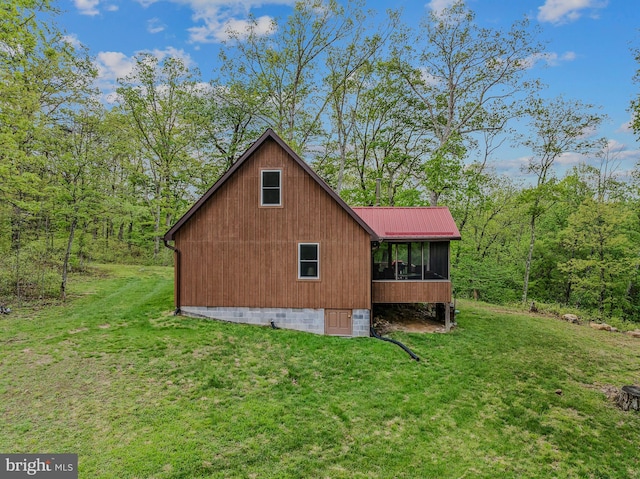 82 Vista River Ln, Paw Paw, WV 25434 - view of home's exterior featuring a lawn, metal roof, a view of trees, and a sunroom