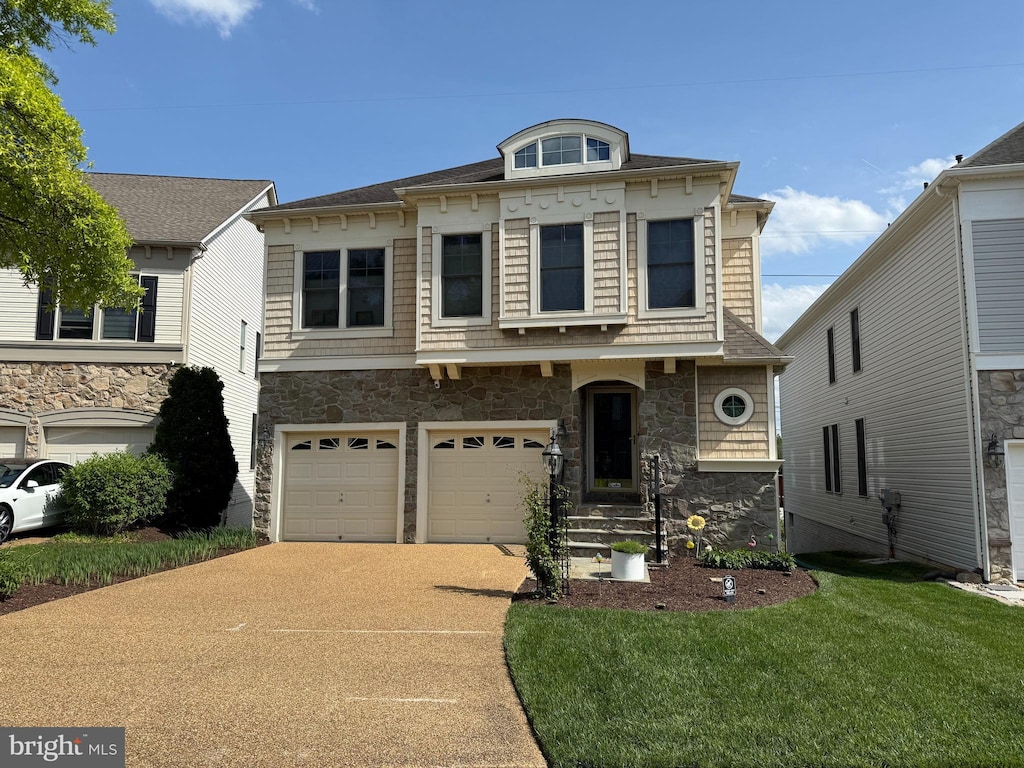view of front of home featuring an attached garage, a front yard, driveway, and stone siding