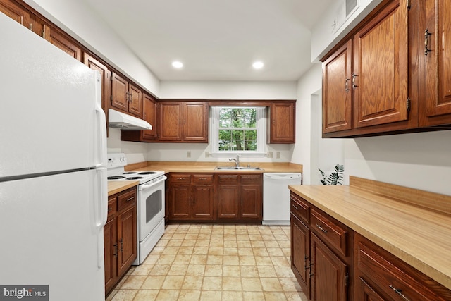 309 Camden Dr, Fredericksburg, VA 22405 - kitchen with white appliances, a sink, under cabinet range hood, light countertops, and recessed lighting