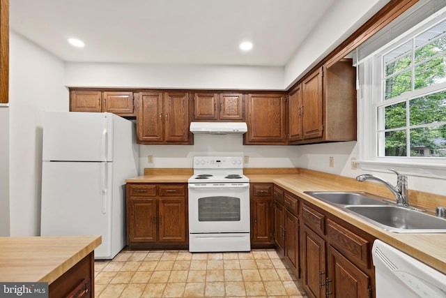 309 Camden Dr, Fredericksburg, VA 22405 - kitchen featuring white appliances, under cabinet range hood, a sink, light countertops, and recessed lighting