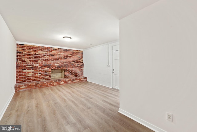 309 Camden Dr, Fredericksburg, VA 22405 - unfurnished living room featuring baseboards, a brick fireplace, wood finished floors, and brick wall