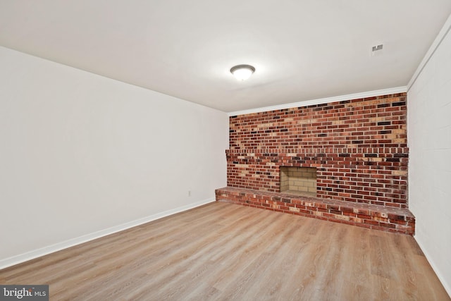 309 Camden Dr, Fredericksburg, VA 22405 - unfurnished living room featuring wood finished floors, baseboards, and a brick fireplace