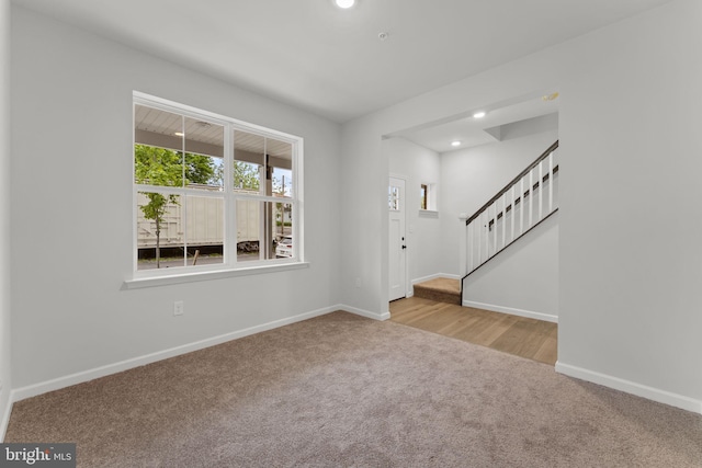 entrance foyer with carpet flooring, recessed lighting, baseboards, and stairs