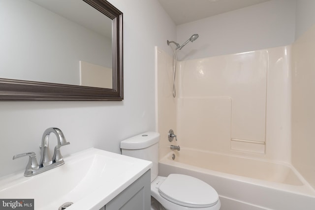 full bathroom featuring toilet, vanity, and  shower combination