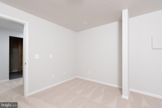 unfurnished bedroom featuring light carpet and baseboards