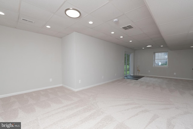 unfurnished room featuring light colored carpet, a drop ceiling, baseboards, and recessed lighting