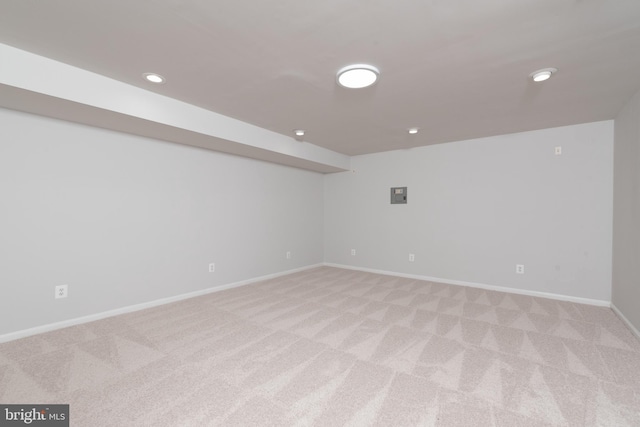 spare room featuring light colored carpet, baseboards, and recessed lighting