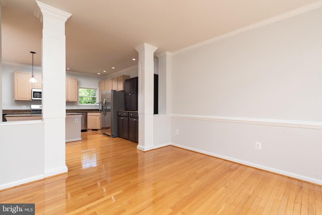 unfurnished living room featuring decorative columns, light wood finished floors, ornamental molding, baseboards, and recessed lighting