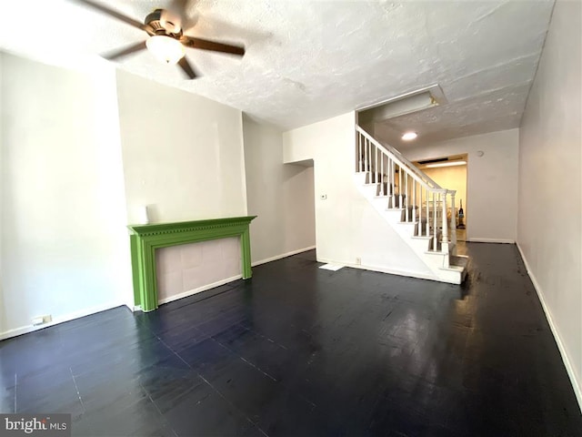 1321 James St, Baltimore, MD 21223 - unfurnished living room featuring baseboards, a ceiling fan, a textured ceiling, and stairway