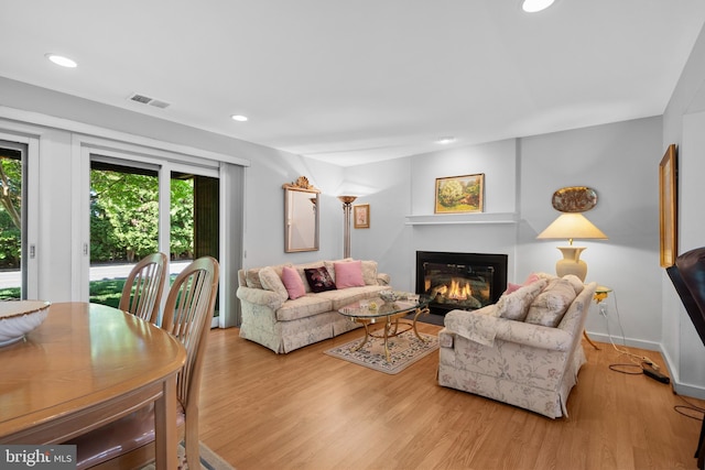 5025A S Convent Ln Unit 142, Philadelphia, PA 19114 - living area featuring a glass covered fireplace, wood finished floors, recessed lighting, and baseboards