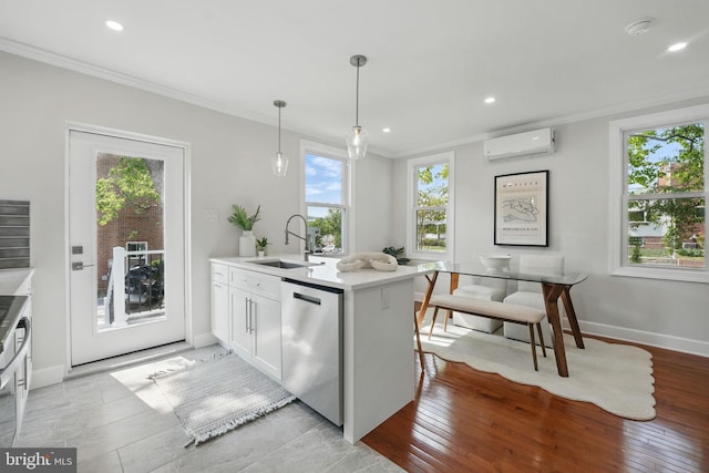 kitchen with stainless steel dishwasher, ornamental molding, a wall unit AC, and a sink