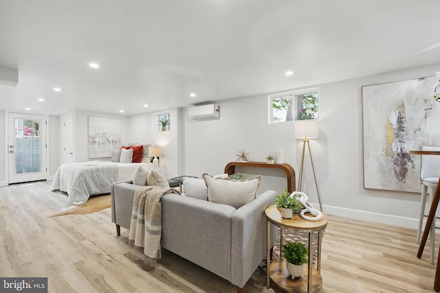 bedroom featuring recessed lighting, a wall mounted air conditioner, baseboards, and wood finished floors
