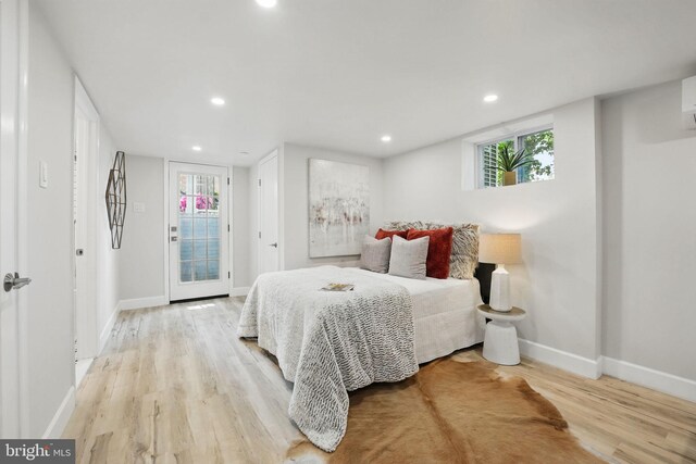 bedroom featuring recessed lighting, baseboards, access to exterior, and wood finished floors