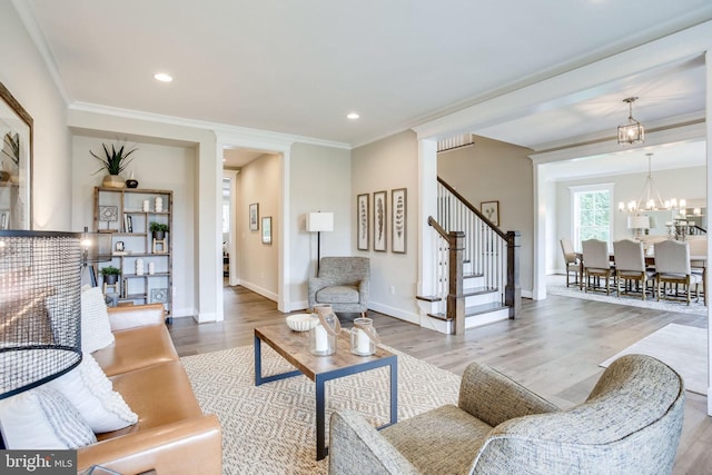3919 Pineland St, Fairfax, VA 22031 - living area with a notable chandelier, ornamental molding, wood finished floors, and stairway