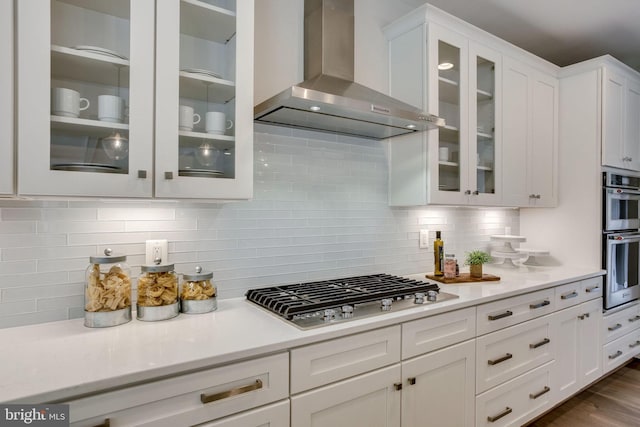 3919 Pineland St, Fairfax, VA 22031 - kitchen featuring light countertops, appliances with stainless steel finishes, wall chimney exhaust hood, and white cabinetry