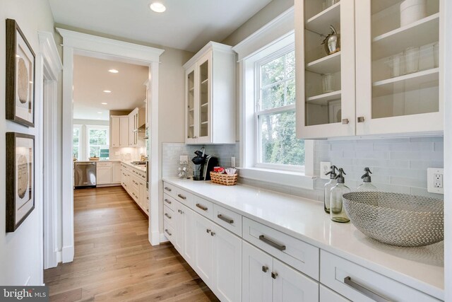 3919 Pineland St, Fairfax, VA 22031 - kitchen with light wood-style floors, white cabinetry, backsplash, and dishwasher