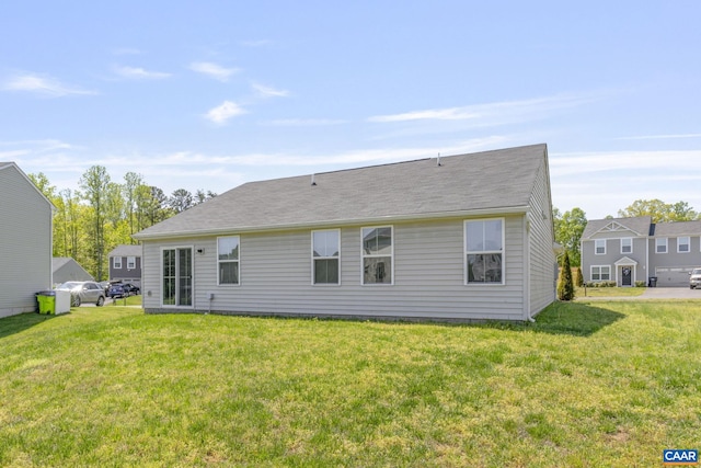 back of property featuring a yard