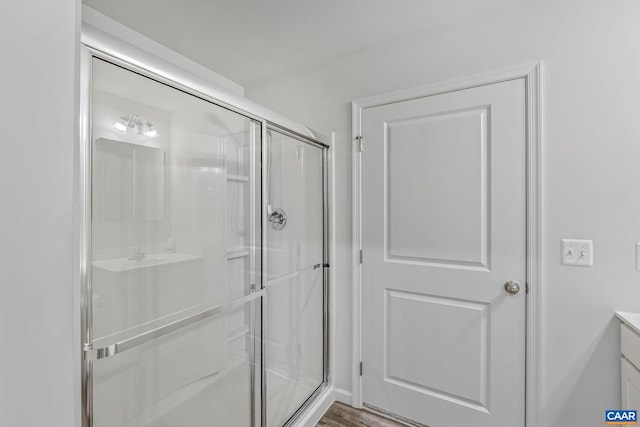 bathroom with a shower stall and vanity