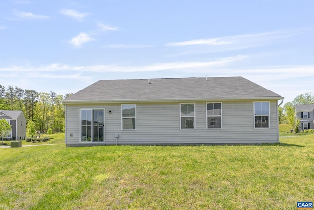 rear view of property featuring a lawn