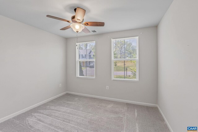 spare room featuring carpet floors, baseboards, and a ceiling fan