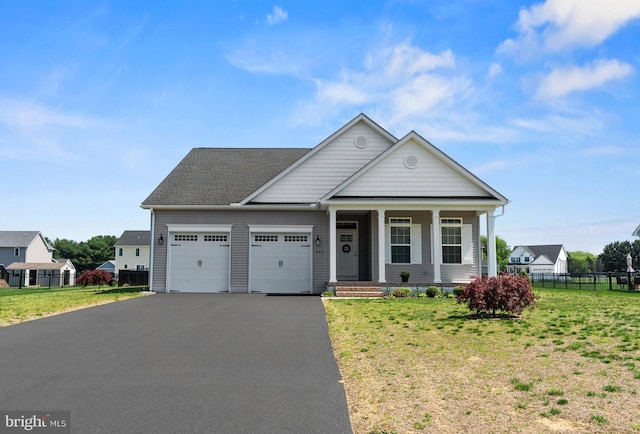 view of front of house featuring fence, an attached garage, and a front yard