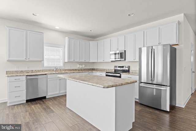 kitchen featuring light countertops, dark wood finished floors, white cabinets, and stainless steel appliances