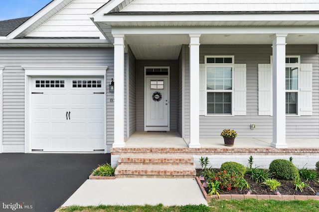 property entrance with a porch and an attached garage