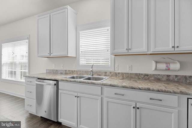 kitchen featuring white cabinets, a sink, dishwasher, light countertops, and dark wood-style floors