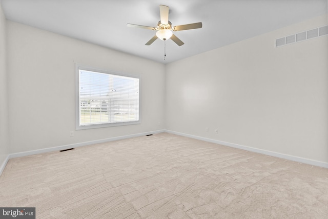 empty room featuring baseboards, ceiling fan, carpet, and visible vents