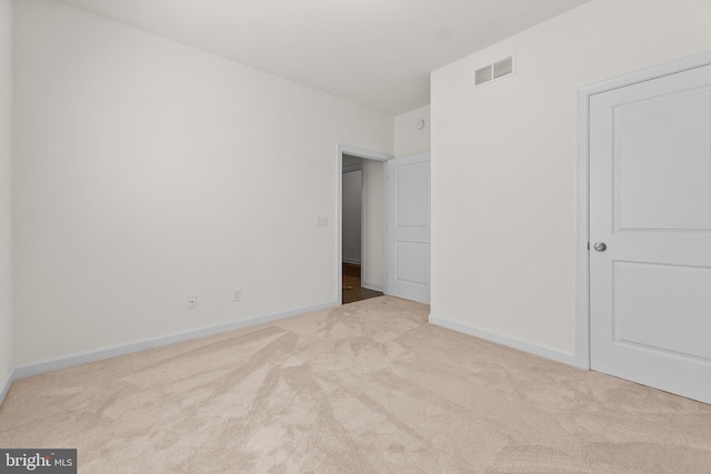 unfurnished bedroom featuring carpet floors, baseboards, and visible vents