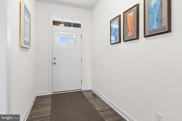 entryway with baseboards and dark wood finished floors