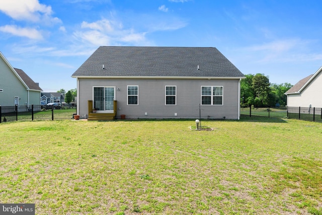 back of house featuring a fenced backyard and a yard