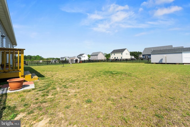 view of yard featuring a fenced backyard and a residential view