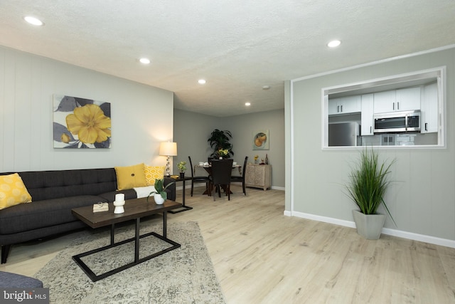 160 Talbott St Unit T5, Rockville, MD 20852 - living area featuring light wood-style flooring, recessed lighting, a textured ceiling, and baseboards