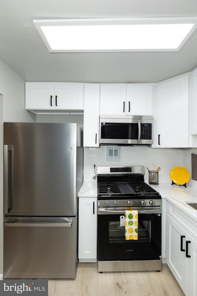 160 Talbott St Unit T5, Rockville, MD 20852 - kitchen with appliances with stainless steel finishes, white cabinetry, and backsplash
