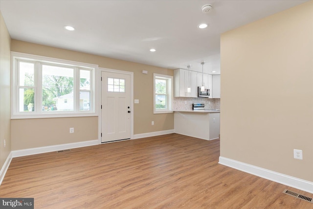 interior space featuring recessed lighting, visible vents, and light wood-style flooring